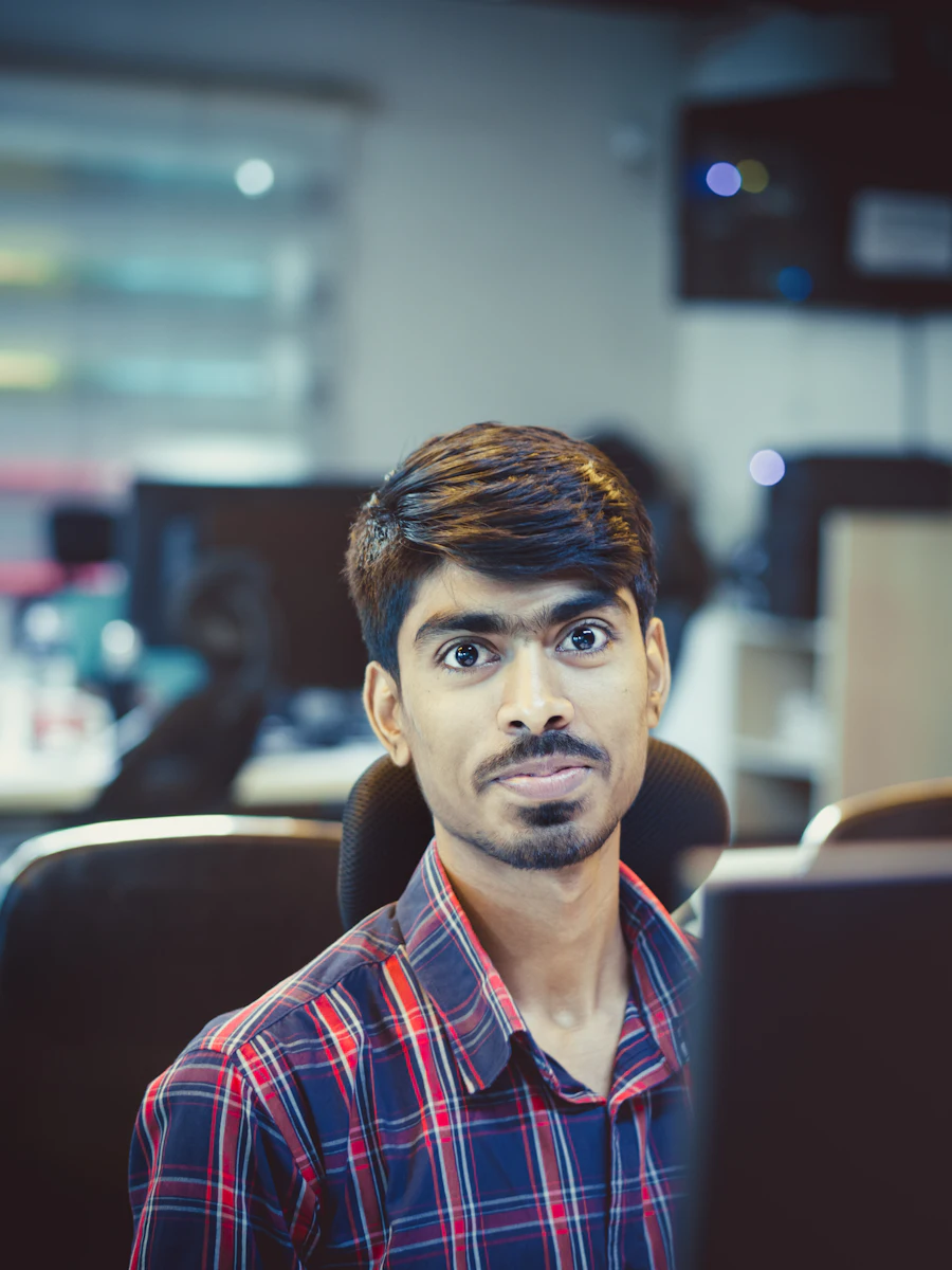 A man in a checked shirt in an office